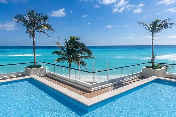 Swimming pool over the turquoise waters of Cancun, Quintana Roo, Mexico, North America