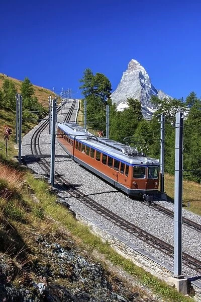 The swiss Bahn train runs on its route with the Matterhorn in the background, Gornergrat