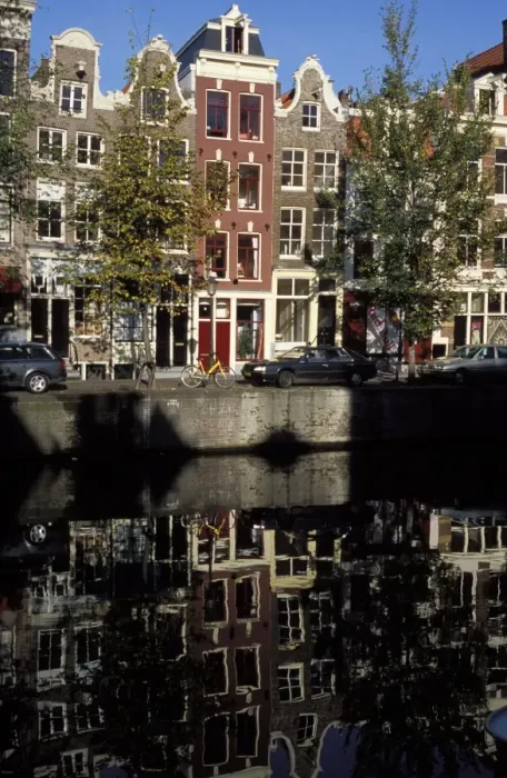 Framed Print : Tall traditional style houses reflected in the water of a canal Framed Print : Tall traditional style houses reflected in the water of a canal