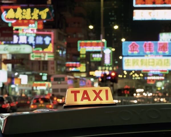 Taxi sign and neon lights at night on Nathan Road, Kowloon, Hong Kong, China, Asia