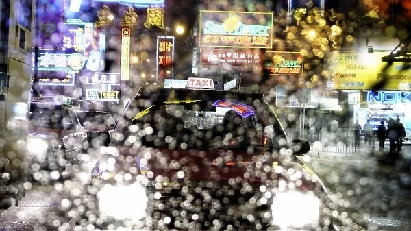 Taxis and traffic with neon signs through water droplets on screen, Hong Kong