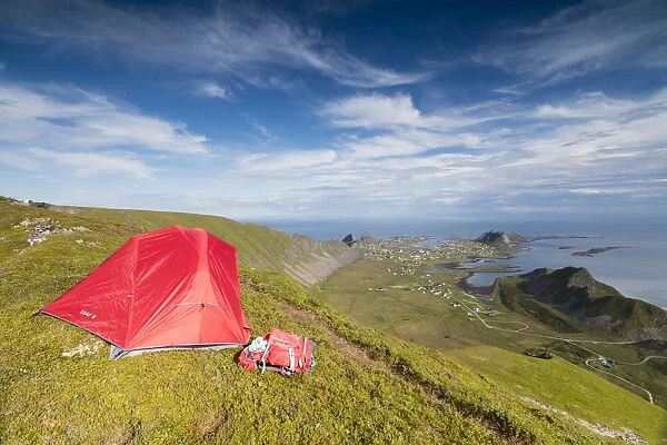 Tent on mountain ridge overlooking meadows and sea, Sorland, Vaeroy Island, Nordland county