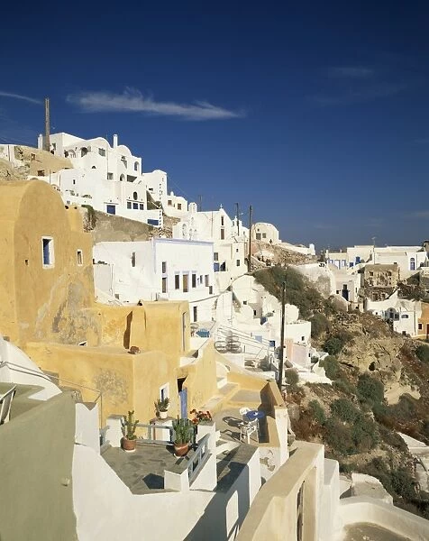 Terrace balconies and white houses of the village of Oia