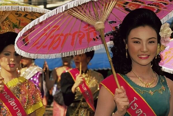 Thai queens holding typical umbrellas during King Narai Reign Fair