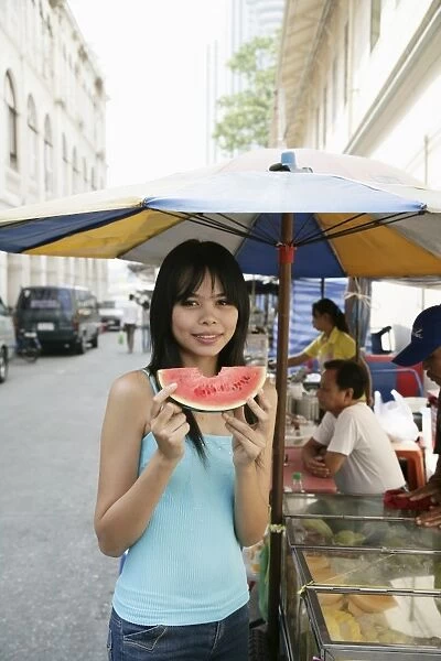 Thai woman with a slice of water melon