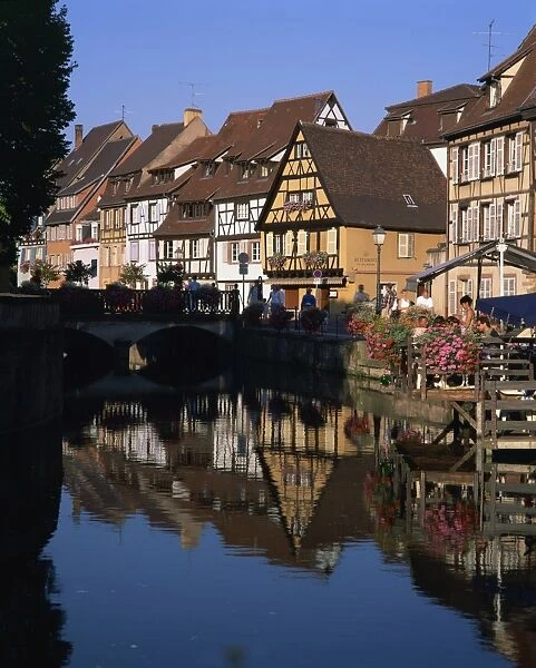 Timbered houses reflected in water in the evening, Petite Venise, Colmar