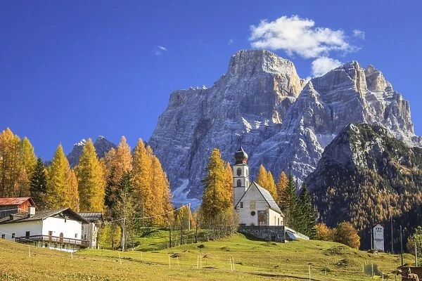 The tiny Church of Selva di Cadore, in the Dolomites, in autumn with the majestic Monte Pelmo in the background, Veneto, Italy, Europe