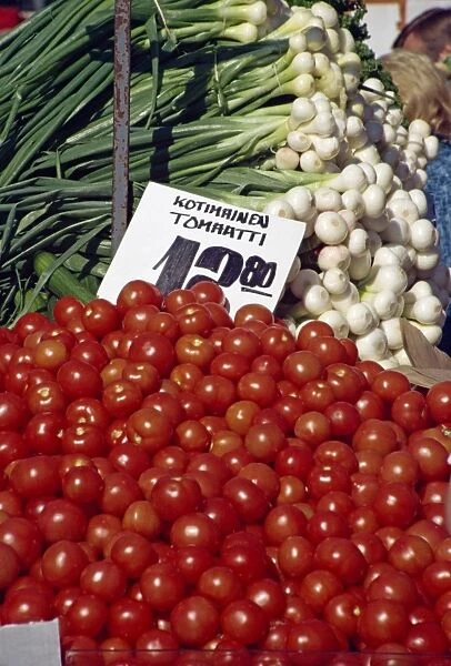 Tomatoes and salad onions on sale at a vegetable market in Helsinki, Finland