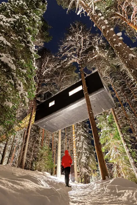 Framed Print : Tourist admires the elevated hotel room capsule shaped among snowy trees in the boreal forest, Swedish Lapland, Harads, Sweden, Scandinavia, Europe