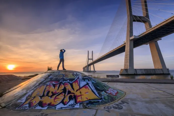 Framed Print : A tourist admires the majestic Vasco da Gama Bridge over the River Tagus, Parque das Nacoes Framed Print : A tourist admires the majestic Vasco da Gama Bridge over the River Tagus, Parque das Nacoes