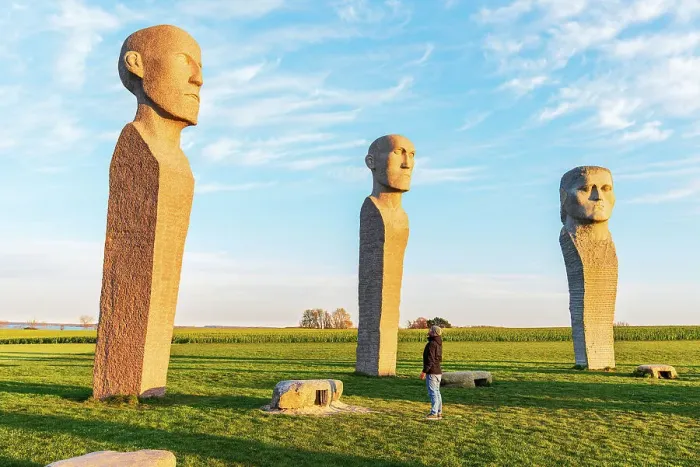 Framed Print : Tourist admiring Dodekalitten statues at sunset, Lolland island, Zealand region, Denmark, Europe Framed Print : Tourist admiring Dodekalitten statues at sunset, Lolland island, Zealand region, Denmark, Europe