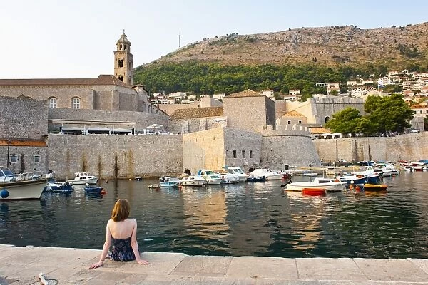 Tourist admiring Dominican Monastery, Dubrovnik Old Town, UNESCO World Heritage Site, Dubrovnik, Dalmatian Coast, Croatia, Europe