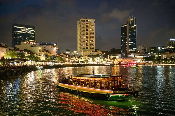 Tourist boat near the historic Boat Quay in Singapore river at dusk, Singapore, Southeast