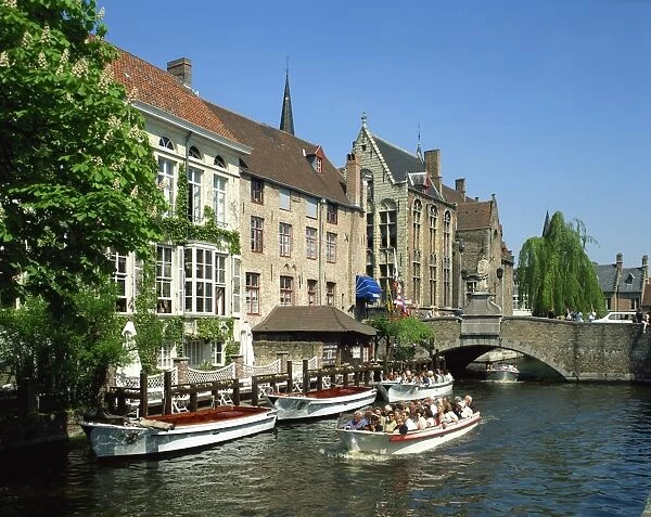 Tourist boat trip on canals of Bruges, Belgium, Europe