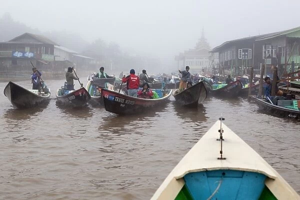 Tourist boats in early morning fog at jetty, Nyaungshwe, Inle Lake, Shan State, Myanmar (Burma), Asia