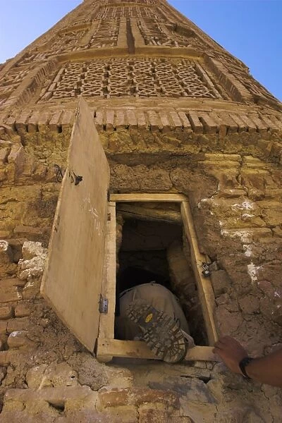 Tourist climbing into the minaret by a window, 12th Century Minaret of Jam