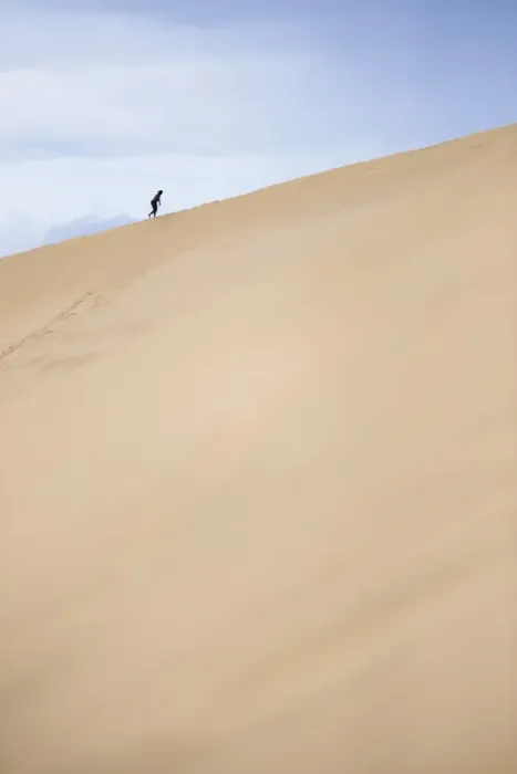 Framed Print : Tourist climbing Te Paki Sand Dunes on 90 Mile Beach, Northland, North Island, New Zealand Framed Print : Tourist climbing Te Paki Sand Dunes on 90 Mile Beach, Northland, North Island, New Zealand