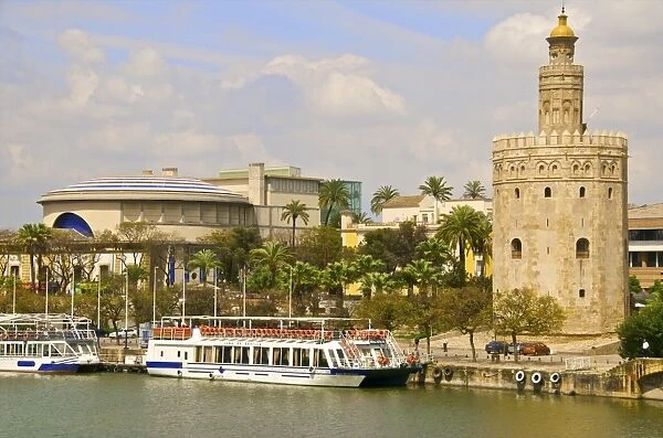 Tourist cruise boat on Guadalquivir river, in front of Theatro de la Maestranza