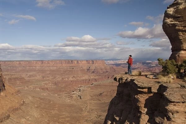 Tourist enjoying the view at Shafer Canyon Overlook, Canyonlands National Park