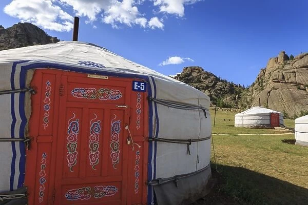 Tourist ger camp in front of rocky outcrop in fine weather in summer, Terelj National Park