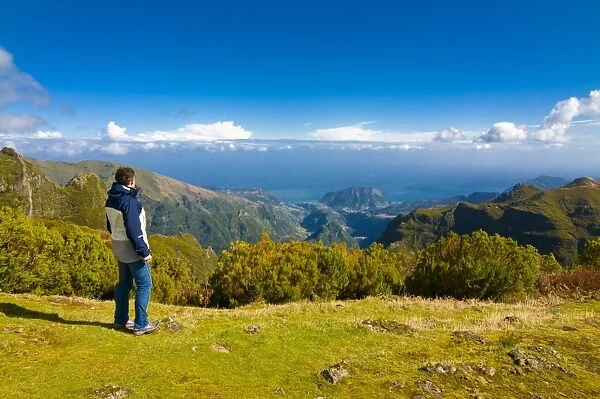 Tourist looking at the stunning scenery of Pico de Ariero, Madeira, Portugal, Europe