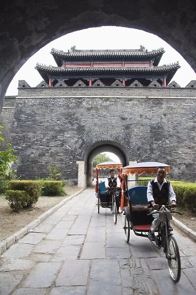 Tourist rickshaw at a city gate watch tower, Qufu City UNESCO World Heritage Site