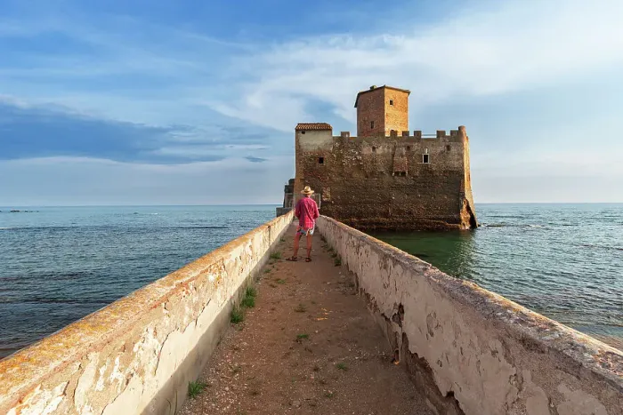 Framed Print : Tourist standing on top of the boardwalk admiring Torre Astura Castle, Nettuno municipality, province of Rome, Tyrrhenian sea, Latium (Lazio), Italy, Europe Framed Print : Tourist standing on top of the boardwalk admiring Torre Astura Castle, Nettuno municipality, province of Rome, Tyrrhenian sea, Latium (Lazio), Italy, Europe
