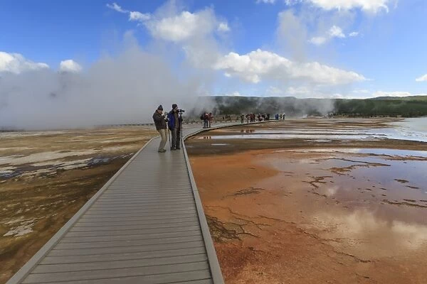 Tourist taking a photograph of Grand Prismatic Spring, Midway Geyser Basin, Yellowstone National Park, UNESCO World Heritage Site, Wyoming, United States of America, North America