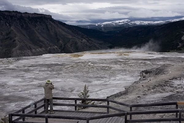 Tourist viewing geysers, Yellowstone National Park, UNESCO World Heritage Site