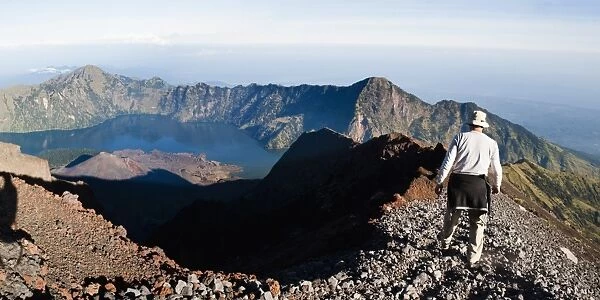 Tourist walking around the crater rim at the 3726m summit of Mount Rinjani volcano, Lombok, Indonesia, Southeast Asia, Asia