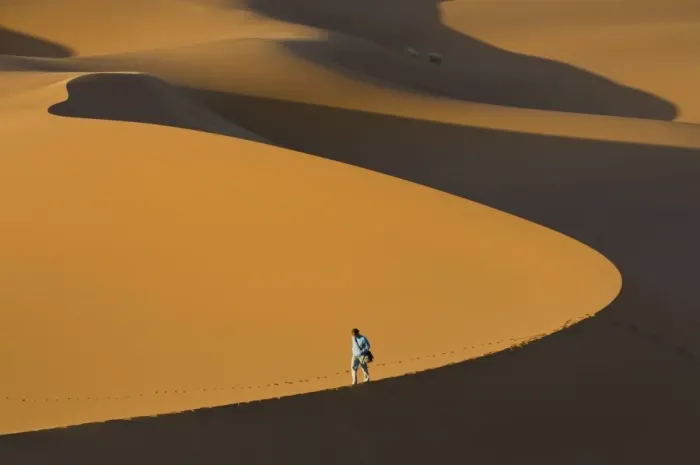 Framed Print : Tourist walking along a giant sand dune, Merzouga, Morocco, North Africa, Africa Framed Print : Tourist walking along a giant sand dune, Merzouga, Morocco, North Africa, Africa