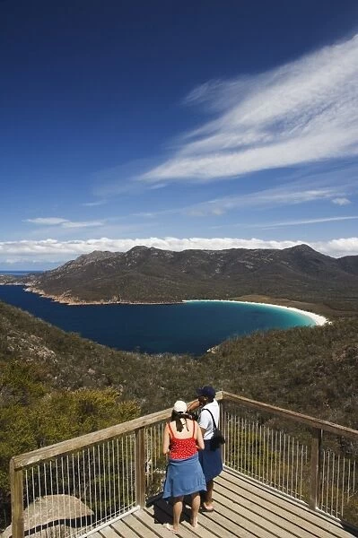 Tourists admiring the view of Wineglass Bay, Coles Bay, Freycinet Peninsula, Freycinet National Park, Tasmania, Australia