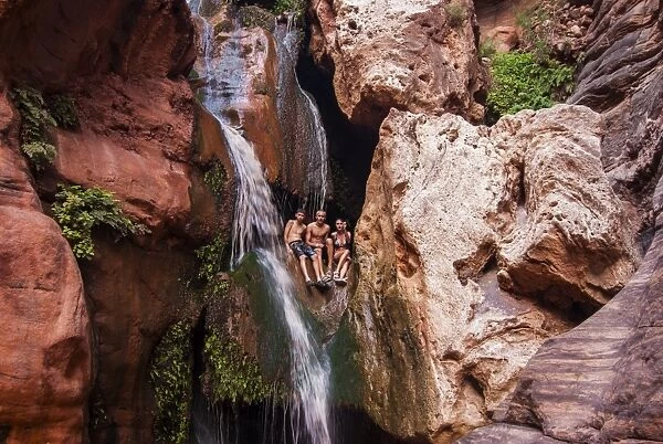 Tourists bathing in a waterfall, seen while rafting down the Colorado River, Grand Canyon, Arizona, United States of America, North America