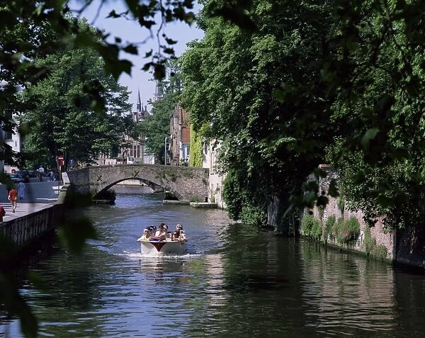 Tourists in boat on canal, Bruges, Belgium, Europe