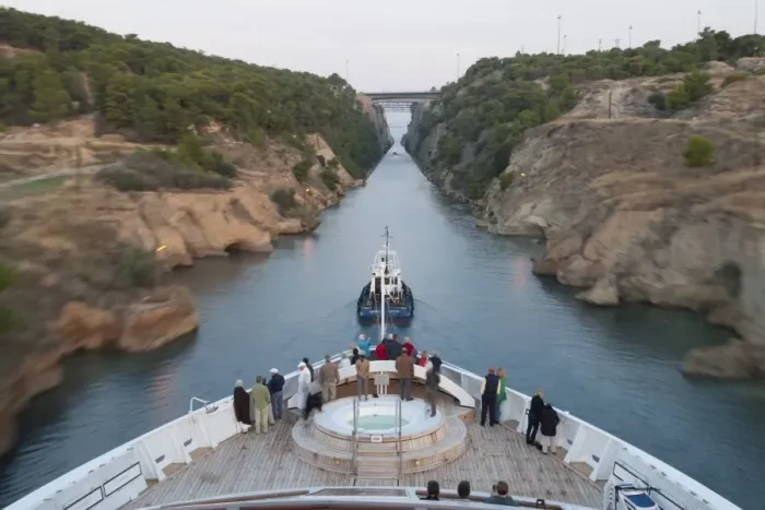 Framed Print : Tourists on the bow of a small cruise ship being pulled by a tug, early morning transit of Corinth Canal, Greece, Europe Framed Print : Tourists on the bow of a small cruise ship being pulled by a tug, early morning transit of Corinth Canal, Greece, Europe