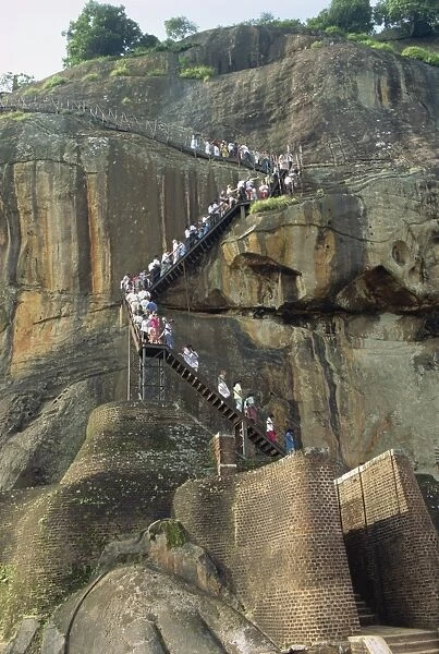 Tourists climbing the rock