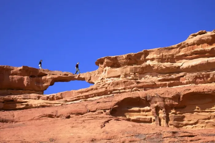 Framed Print : Tourists climbing at Wadi Rum, Jordan, Middle East Framed Print : Tourists climbing at Wadi Rum, Jordan, Middle East