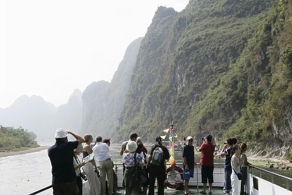 Tourists on cruise boat on Li River between Guilin and Yangshuo, Guilin