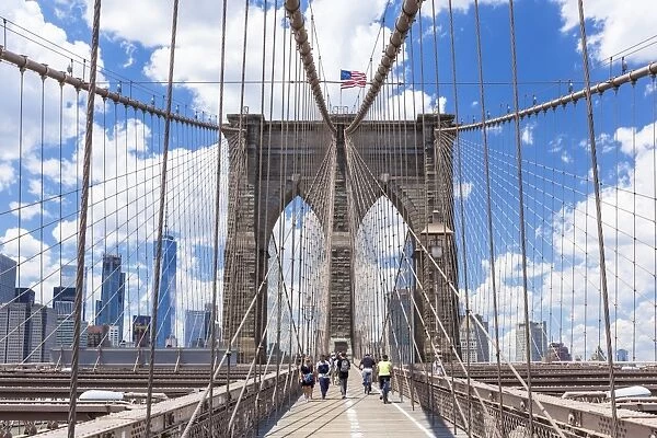 Tourists, cyclists on walkway, Brooklyn Bridge, Lower Manhattan skyline, New York skyline
