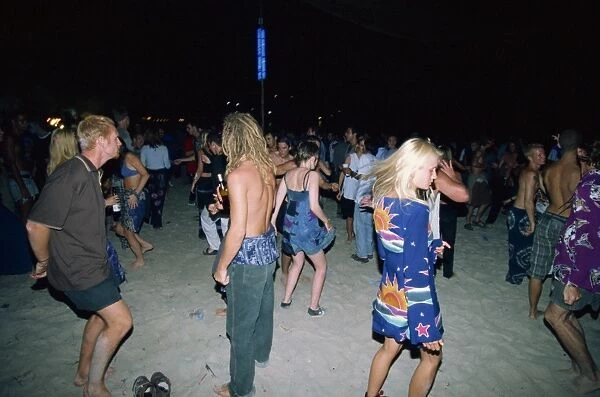 Tourists dancing at a full moon party at Haad Rin Beach