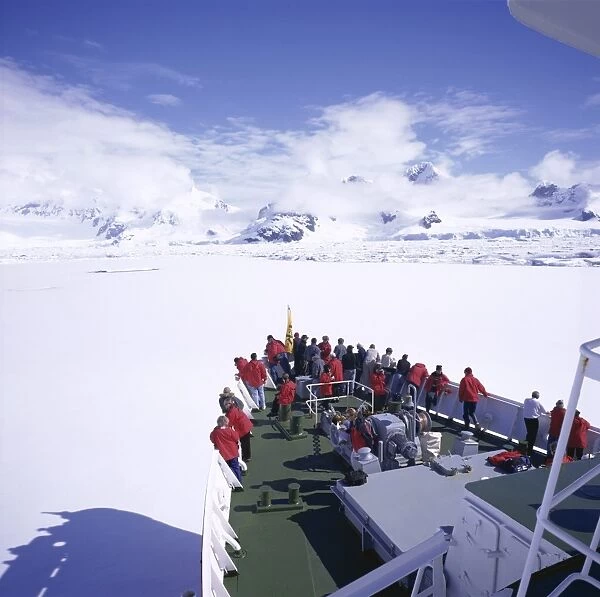 Tourists on deck of a cruise ship, sea ice cruising in fast ice, Antarctic Peninsula
