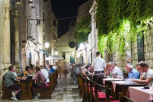 Tourists eating dinner in a restaurant in Dubrovnik Old Town, Dalmatian Coast, Croatia, Europe