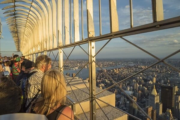 Tourists at the Empire State Building viewing platform enjoying the view, Manhattan, New York City, New York, United States of America, North America