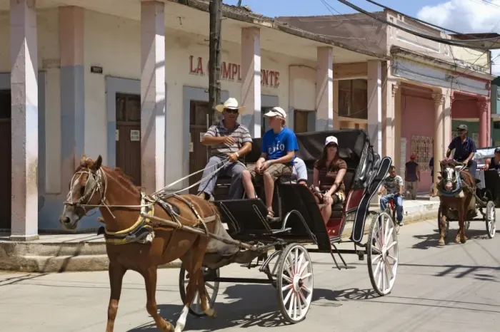 Framed Print : Tourists enjoying a horse-drawn buggy ride through Moron, Ciego de Cvila Framed Print : Tourists enjoying a horse-drawn buggy ride through Moron, Ciego de Cvila