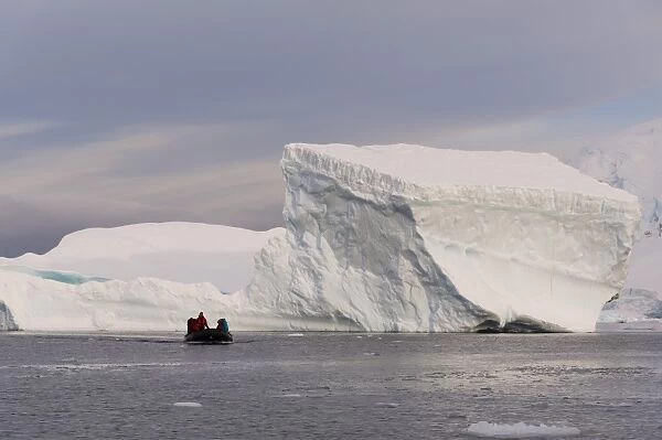Tourists exploring Skontorp Cove in inflatable boat, Paradise Bay, Antarctica, Polar