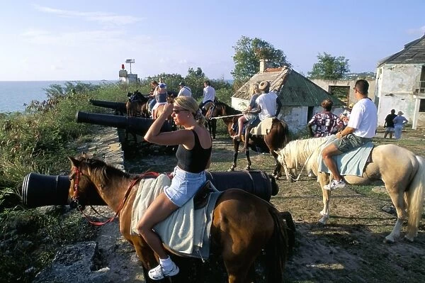 Tourists on horseback in historic Fort James, St