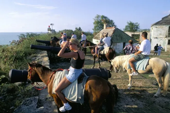 Framed Print : Tourists on horseback in historic Fort James, St Framed Print : Tourists on horseback in historic Fort James, St