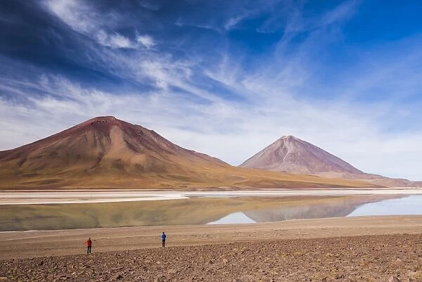 Tourists at Licancabur volcano on right and Laguna Verde, Bolivia near the border with Chile