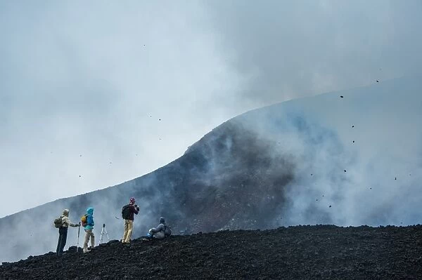 Tourists looking at an active lava eruption on the Tolbachik volcano, Kamchatka, Russia, Eurasia