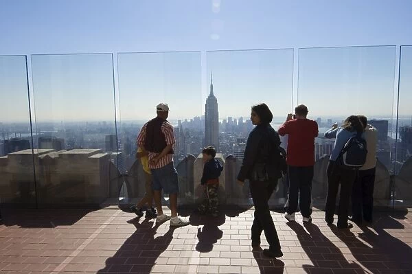 Tourists looking at the Empire State Building and Manhattan